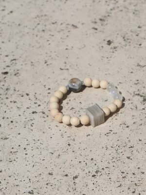 The oneBone in Layered Phantom blends grounding wood with Phantom Quartz, known to enhance clarity and inner strength. A calm, balanced energy for everyday wear.