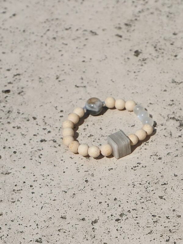 The oneBone in Layered Phantom blends grounding wood with Phantom Quartz, known to enhance clarity and inner strength. A calm, balanced energy for everyday wear.